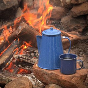 coffee pot and cup by an bonfire