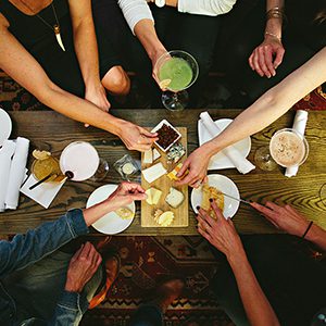 group of friends share charcuterie and drinks